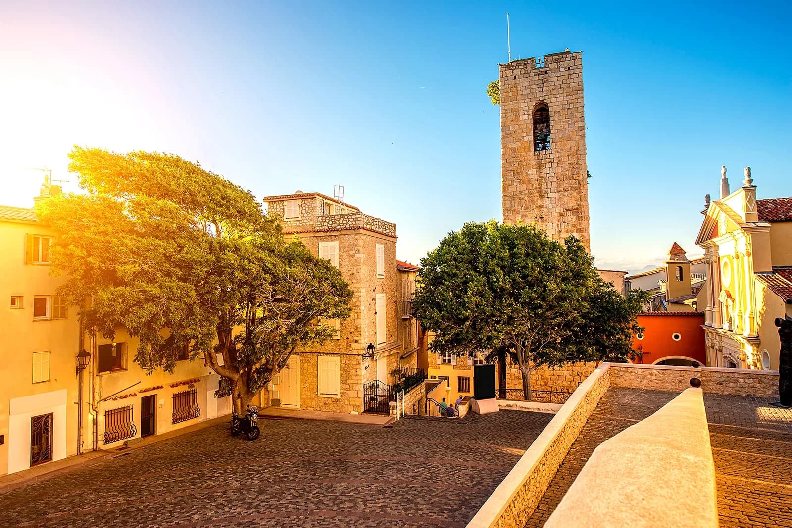 The cobbled square below the cathedral bell tower in Old Antibes, late afternoon