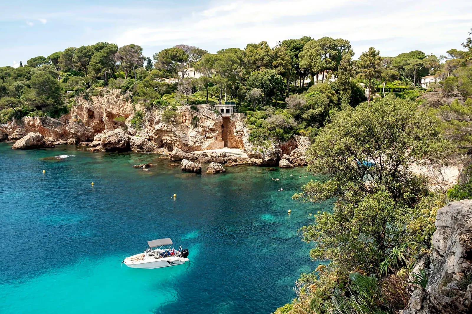 A quiet turquoise cove of the Cap d’Antibes in summer