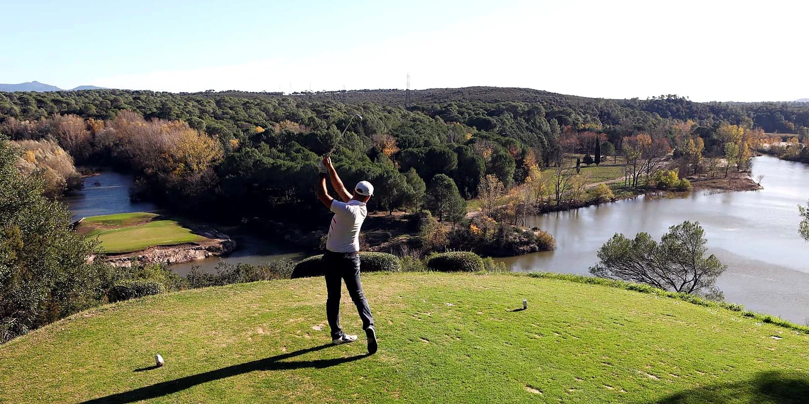 A tee shot over water on a wooded inland course of the Provençal countryside near Antibes