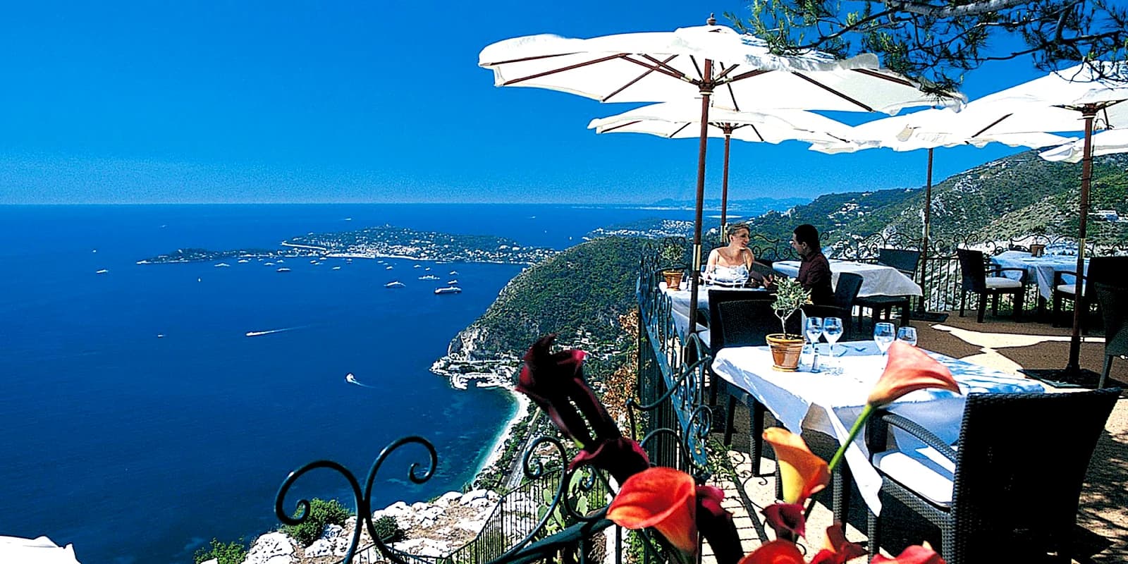 Terrace tables of a starred restaurant in Èze village, a thousand feet above the sea and Cap Ferrat