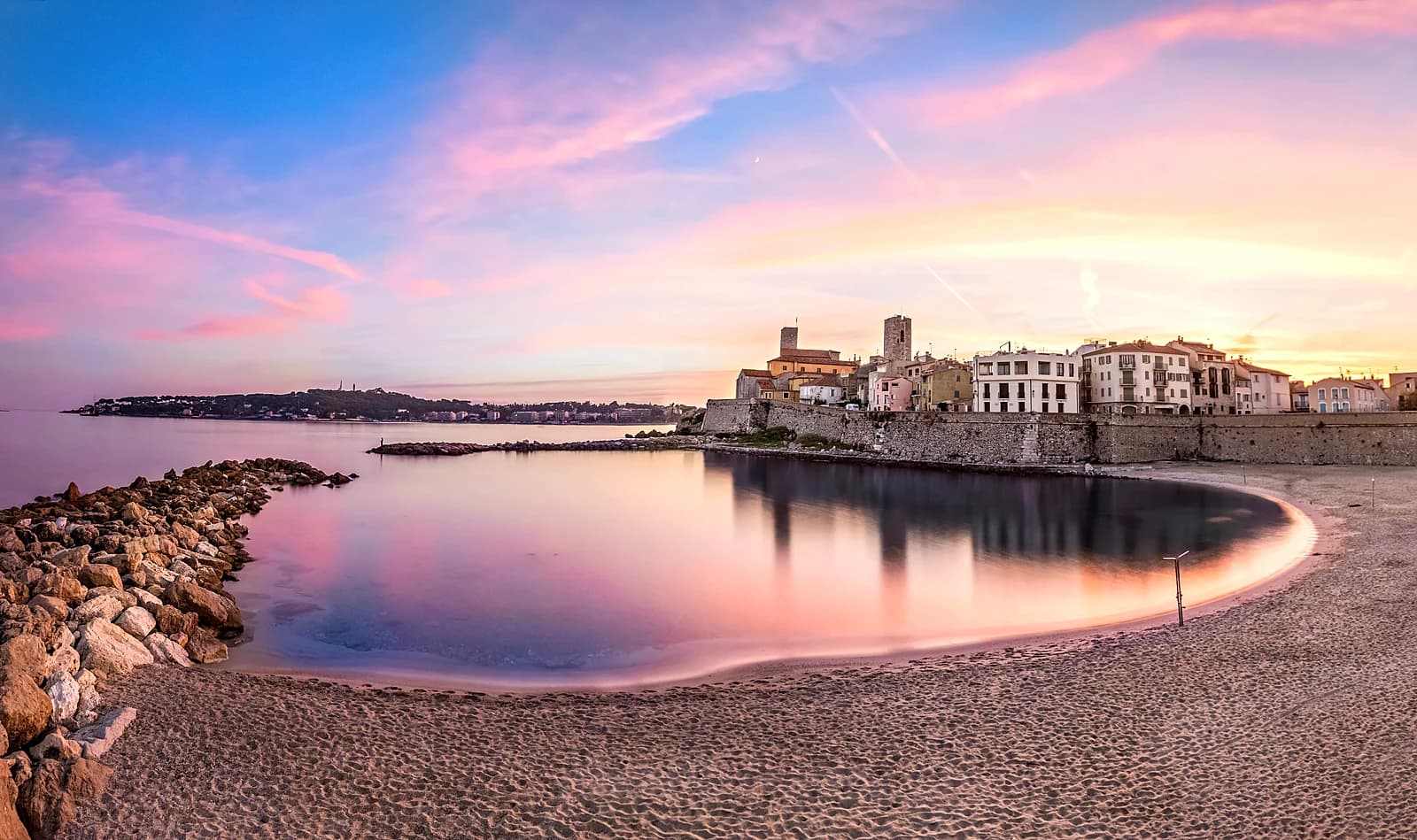 La Gravette beach and Old Antibes at sunset, the bay turned pink