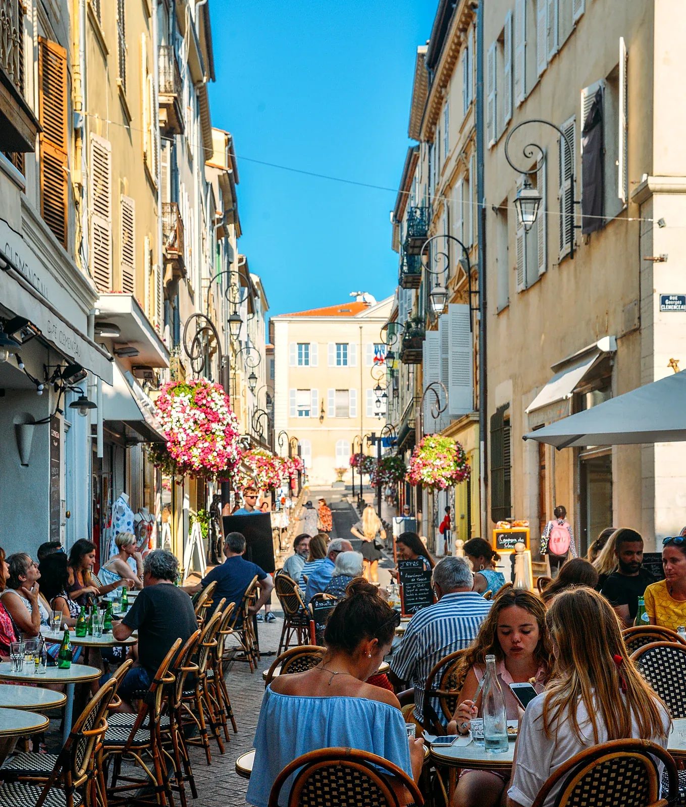 Restaurant terraces on rue Georges Clemenceau in Old Antibes at lunchtime