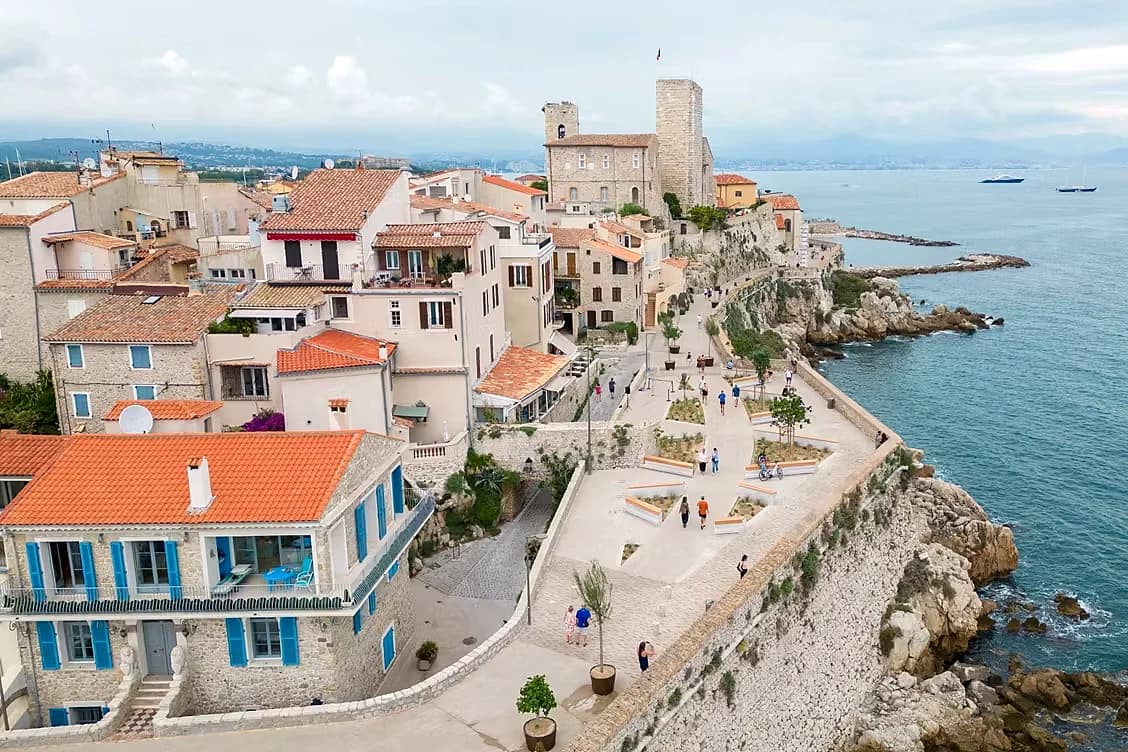The sea-front houses of Old Antibes seen from the ramparts, the promenade running above the water