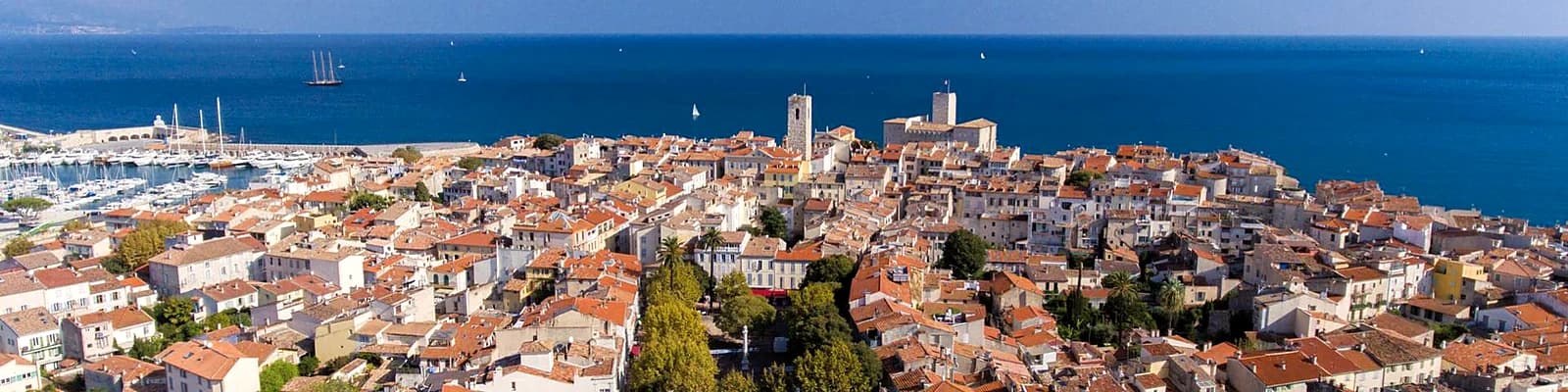 The rooftops of Old Antibes from above, the Mediterranean and the coast beyond