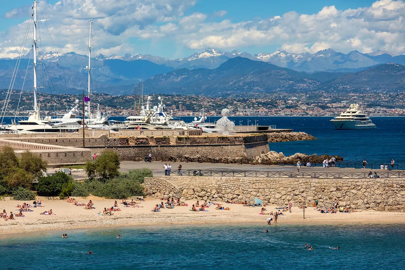 Yachts at Port Vauban and the Gravette seen from the ramparts of Old Antibes, the Alps behind