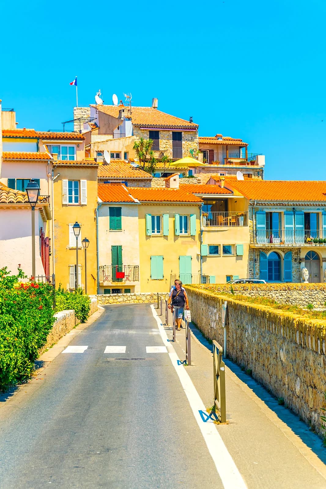 Pastel houses with green shutters along the Promenade Amiral de Grasse, Old Antibes